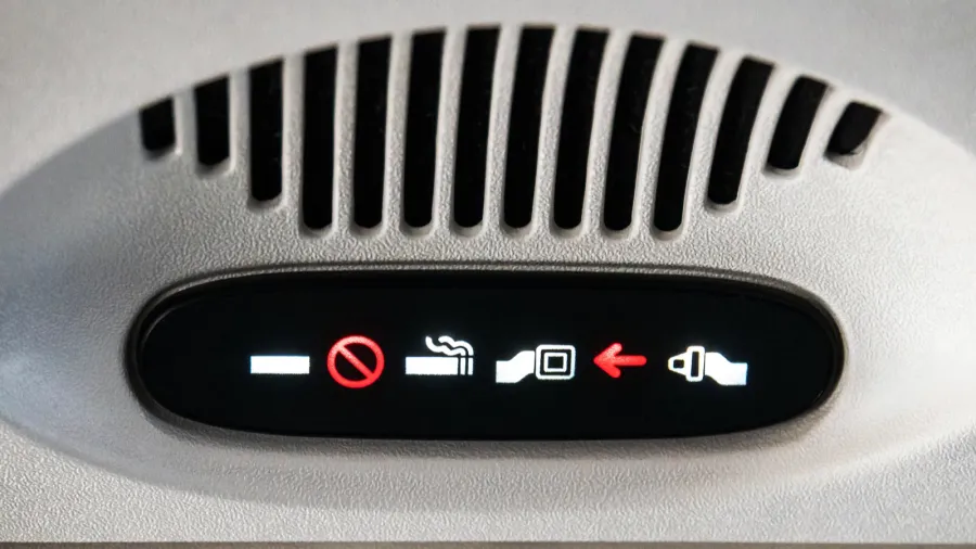 no smoking and fasten seat belt sign inside an airplane