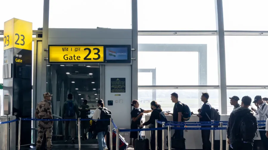 passengers waiting in queue for boarding at airport gate with