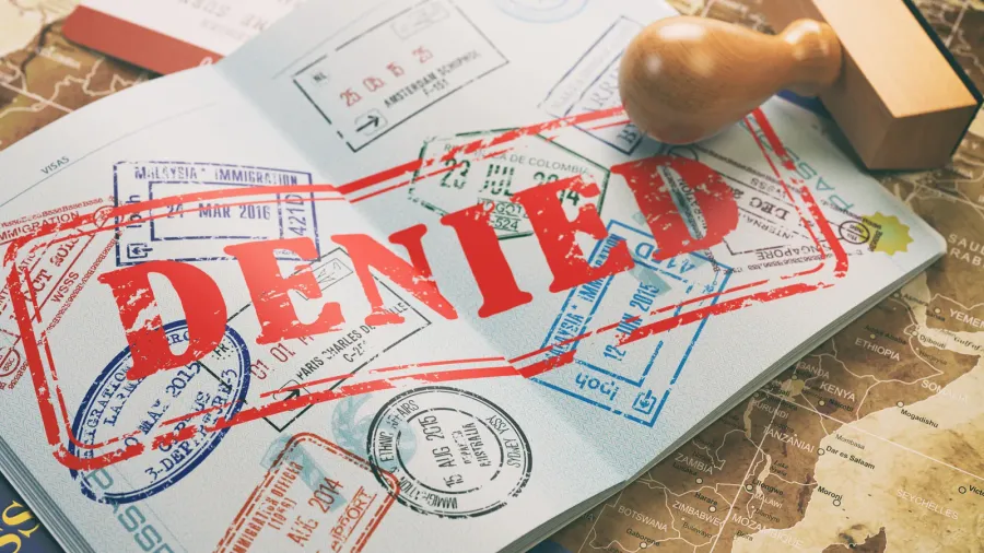passport with denied visa stamp on the map of the