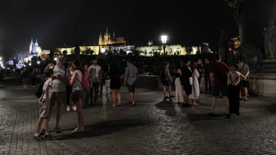 people walk in charles bridge which is a medieval stone
