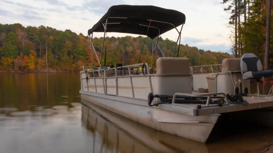 pontoon boat beached on the shore of falls lake in