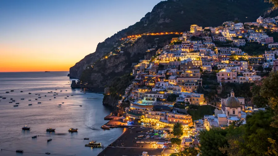 positano italy glowing in the soft hues of dusk along