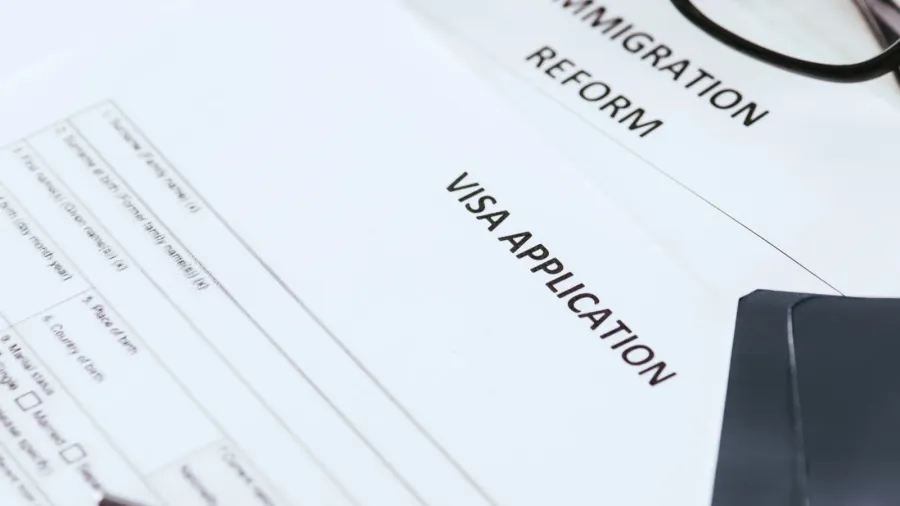 selective focus documents with lettering near glasses and passports
