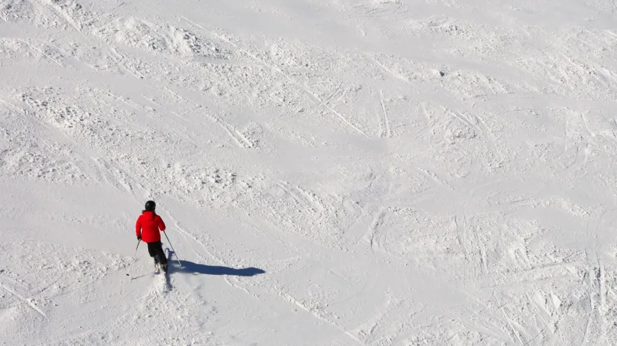 skier in the slope in the white snow in mountain
