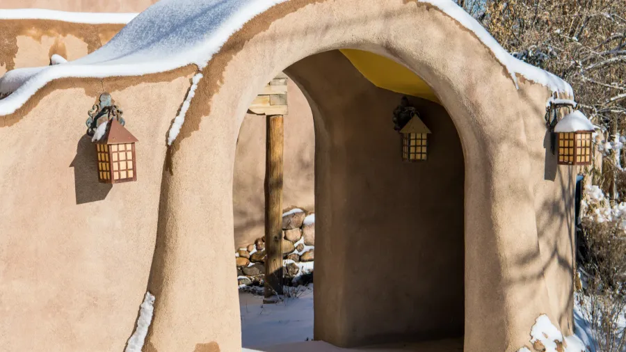 snowy winter scene of a snowcovered adobe wall with an