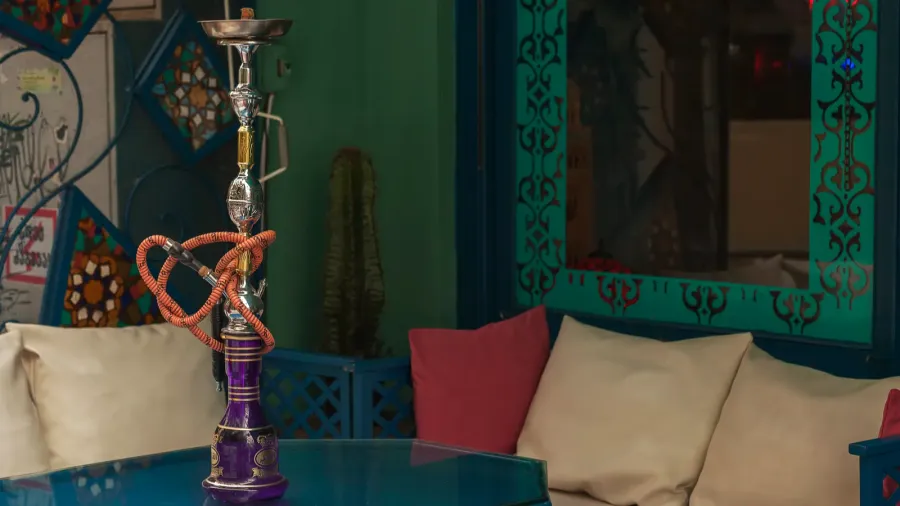 sofas and shisha at a cafe table outdoors