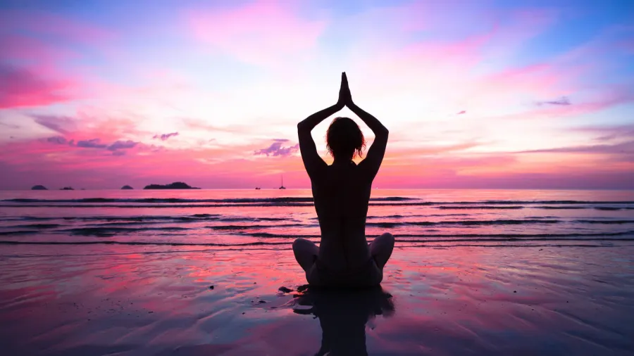 sunset yoga woman on sea coast