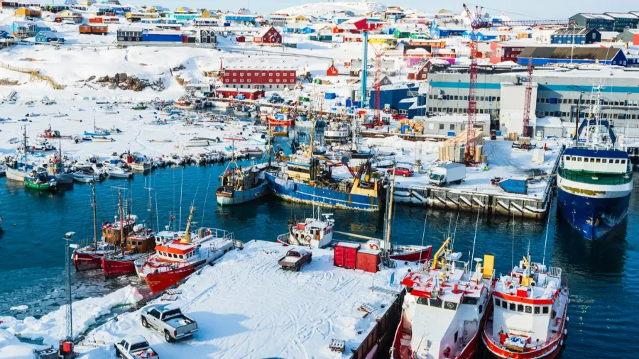 the bustling port of ilulissat features boats resting on the
