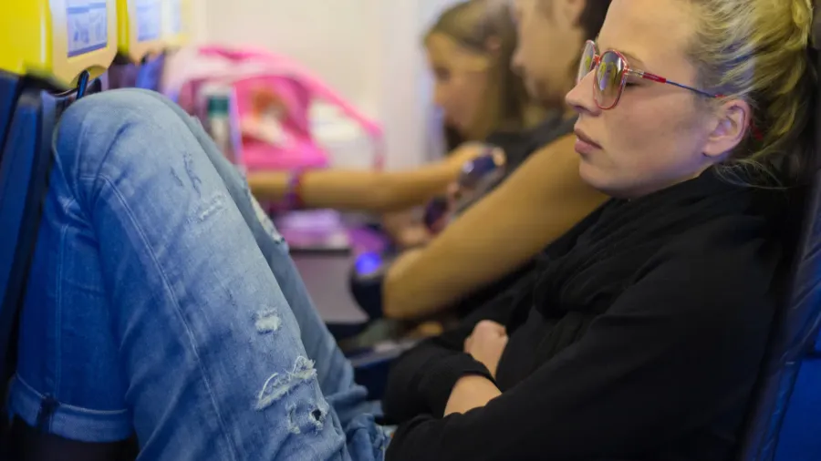 tired lady napping on airplane
