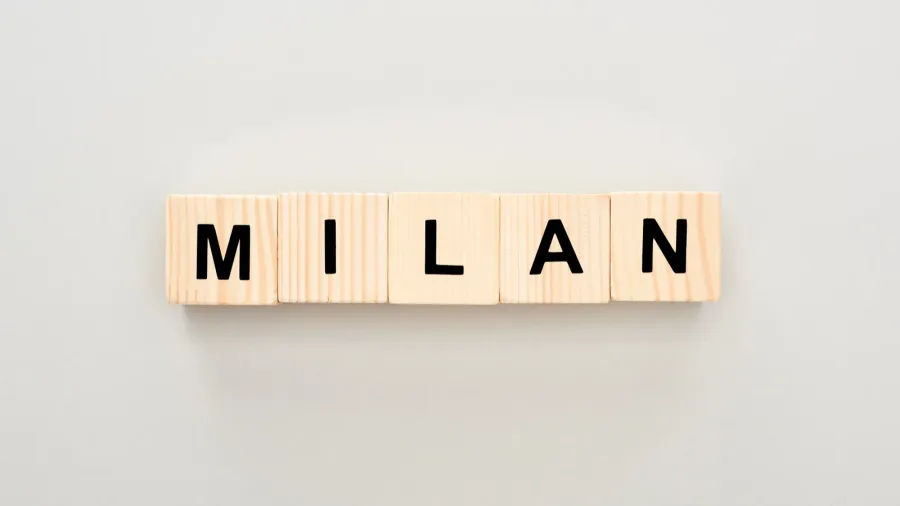 top view of wooden blocks with milan lettering on white