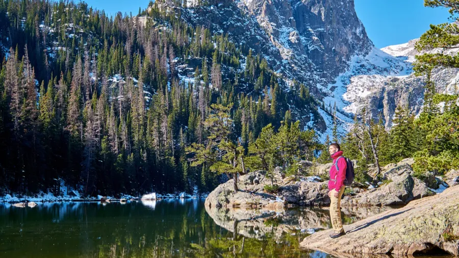 tourist near dream lake at autumn in rocky mountain national
