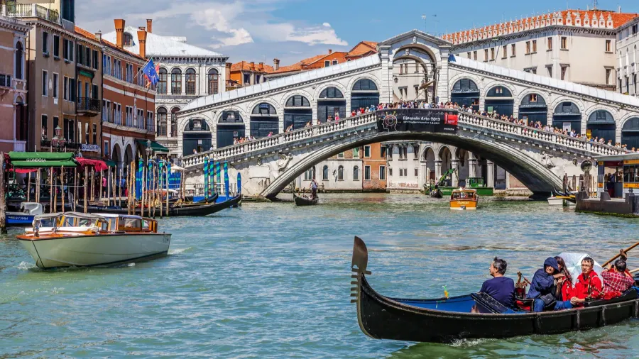 tourists make a walk to the gondola at the grand