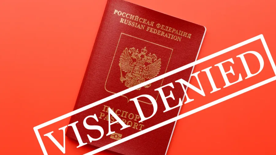 traveling passport on top of red surface with stamp saying