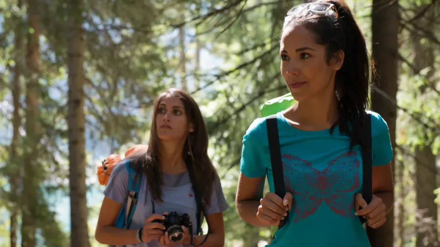 two women walking along hiking trail path