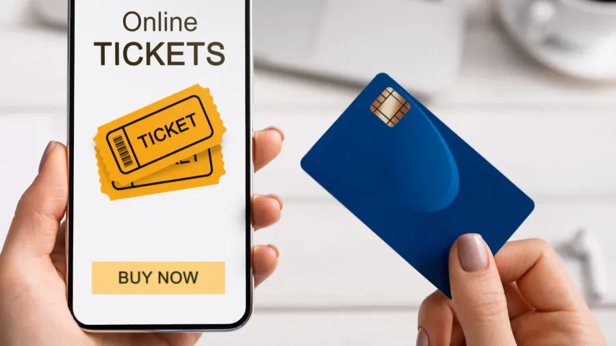 woman holding smartphone with online tickets app and credit card