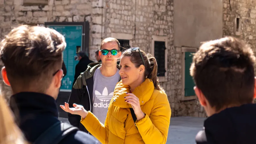 woman tourist guide talking to a group of travellers