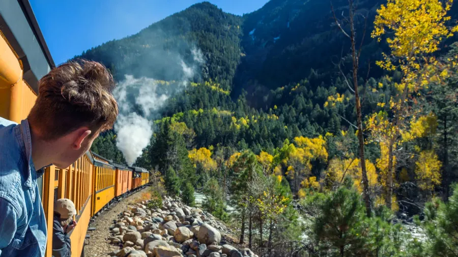 young man looking out of train window