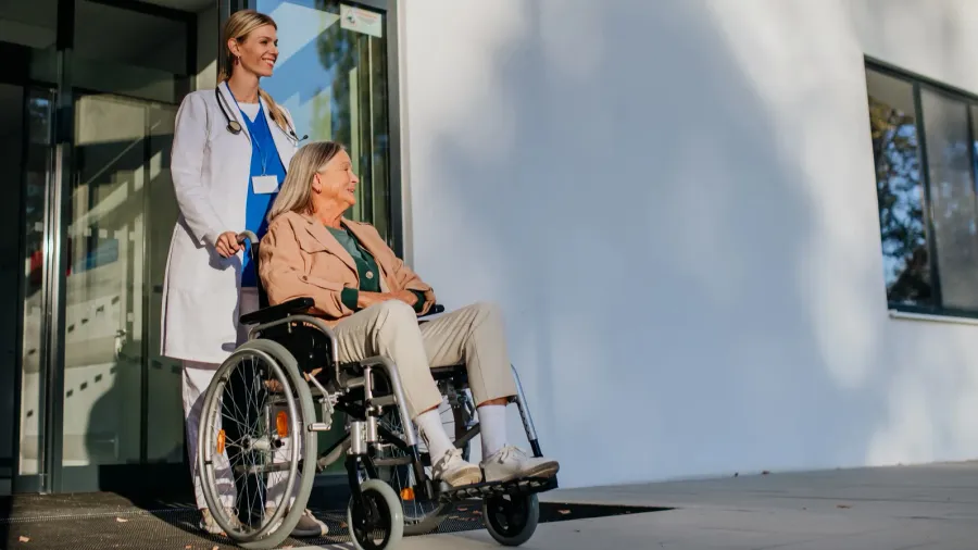 young woman doctor taking care of senior woman at a